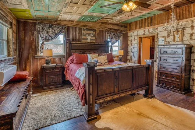 a bed room with a bed and a tv