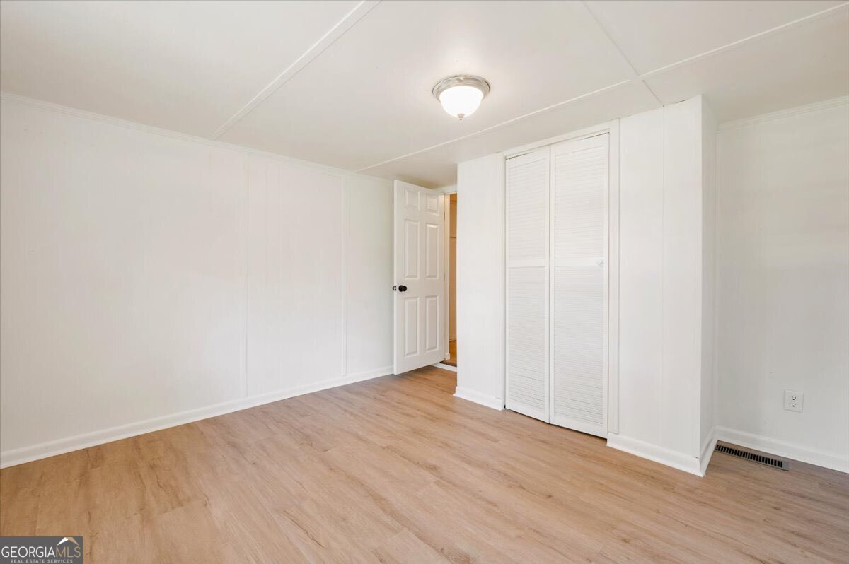 24 Sangster Road Jesup, GA 31545 - Photo 14 of 35 a view of an empty room and wooden floor