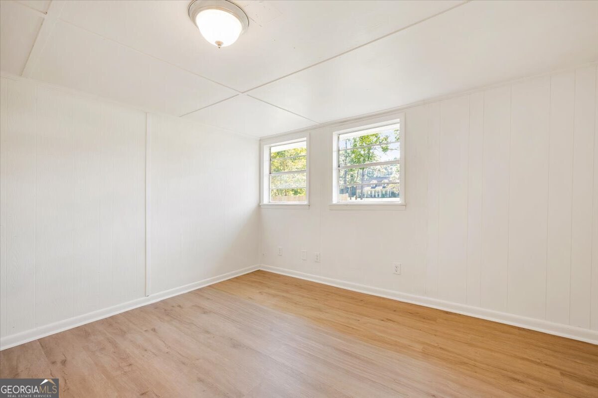 24 Sangster Road Jesup, GA 31545 - Photo 15 of 35 an empty room with wooden floor and windows