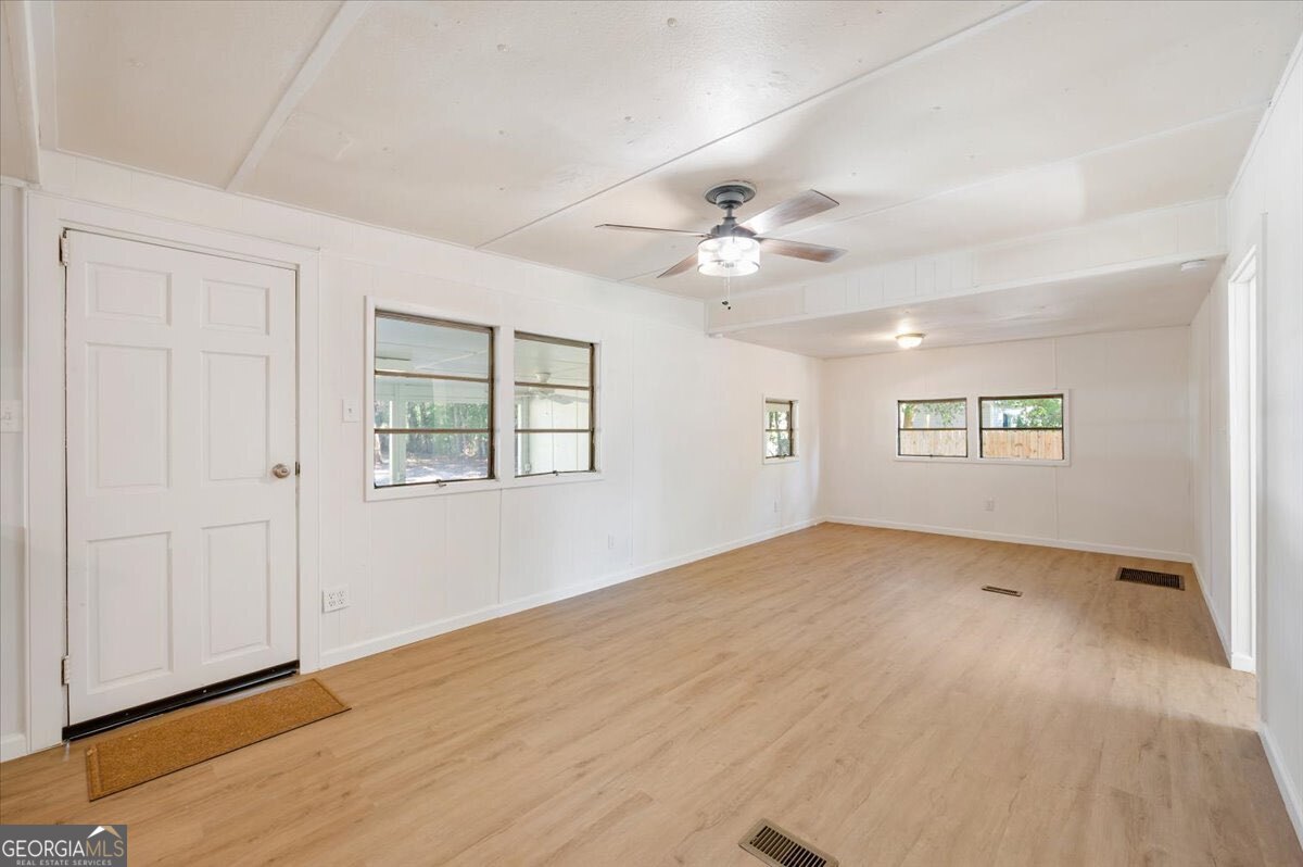24 Sangster Road Jesup, GA 31545 - Photo 20 of 35 an empty room with windows and ceiling fan