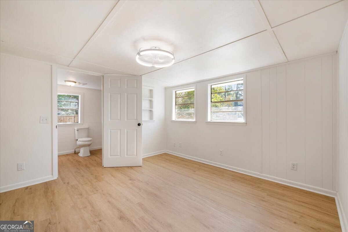 24 Sangster Road Jesup, GA 31545 - Photo 23 of 35 an empty room with wooden floor and windows