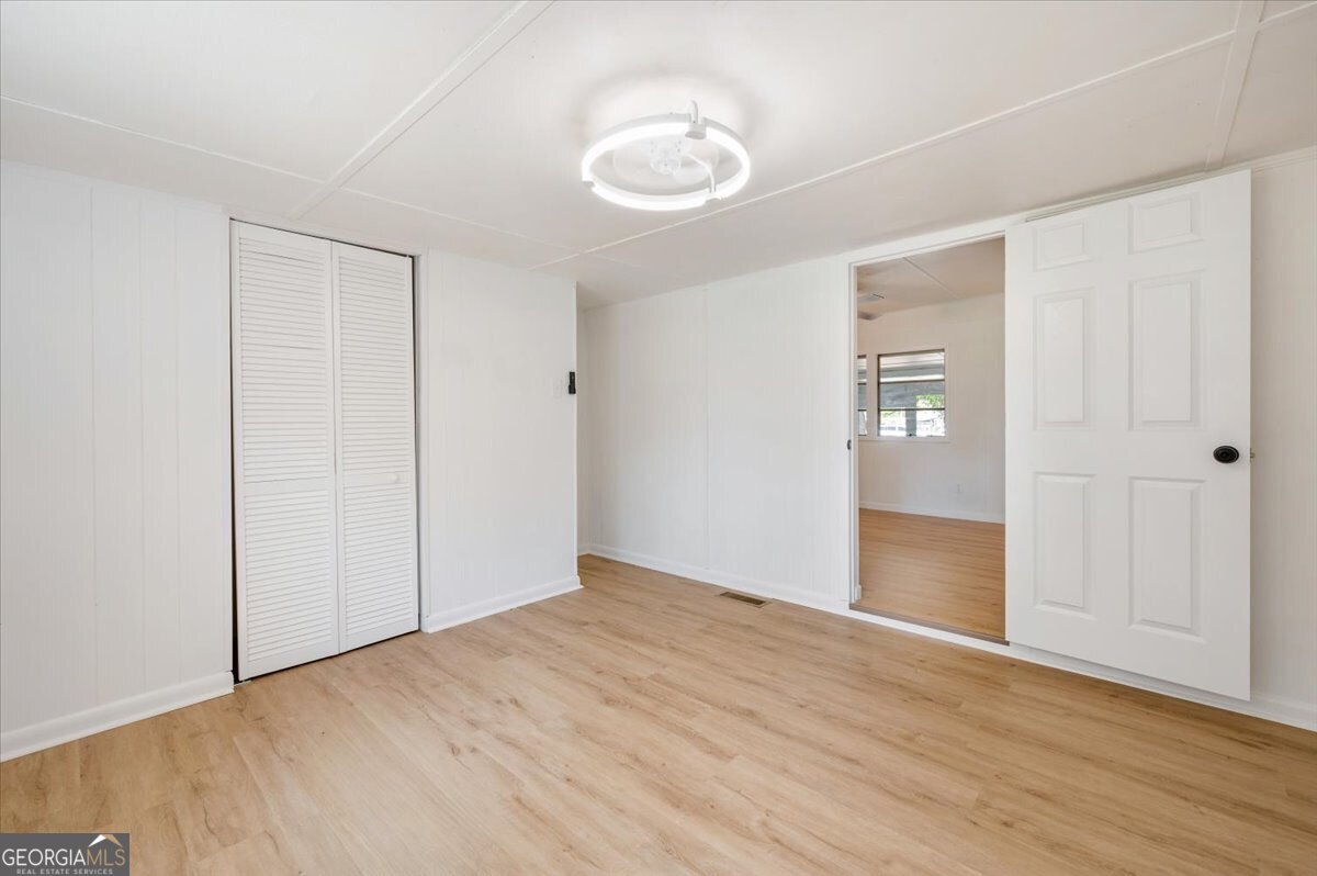24 Sangster Road Jesup, GA 31545 - Photo 24 of 35 an empty room with wooden floor and windows