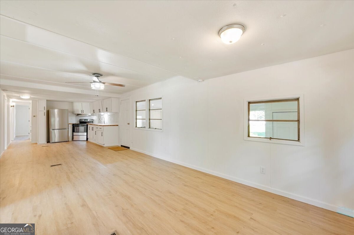 24 Sangster Road Jesup, GA 31545 - Photo 3 of 35 a view of empty room with wooden floor
