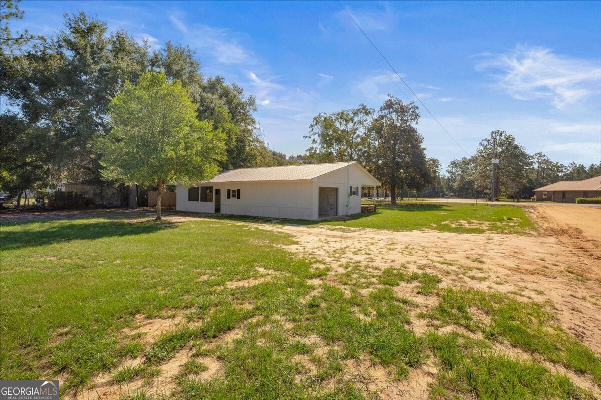 24 Sangster Road Jesup, GA 31545 - Photo 31 of 35 a house view with swimming pool and trees in the background