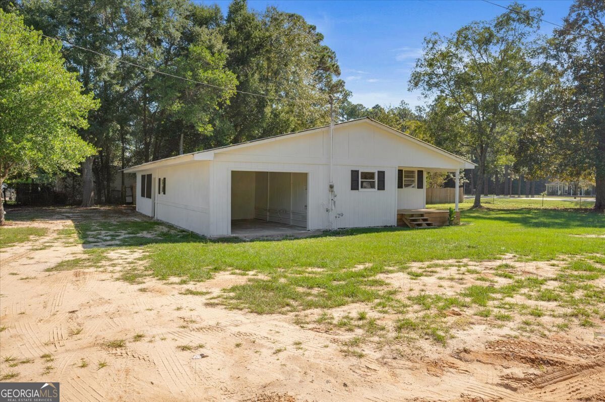 24 Sangster Road Jesup, GA 31545 - Photo 7 of 35 a front view of house with yard and green space
