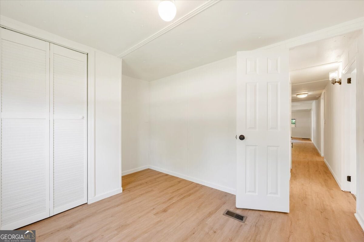 24 Sangster Road Jesup, GA 31545 - Photo 10 of 35 a view of a hallway with wooden floor