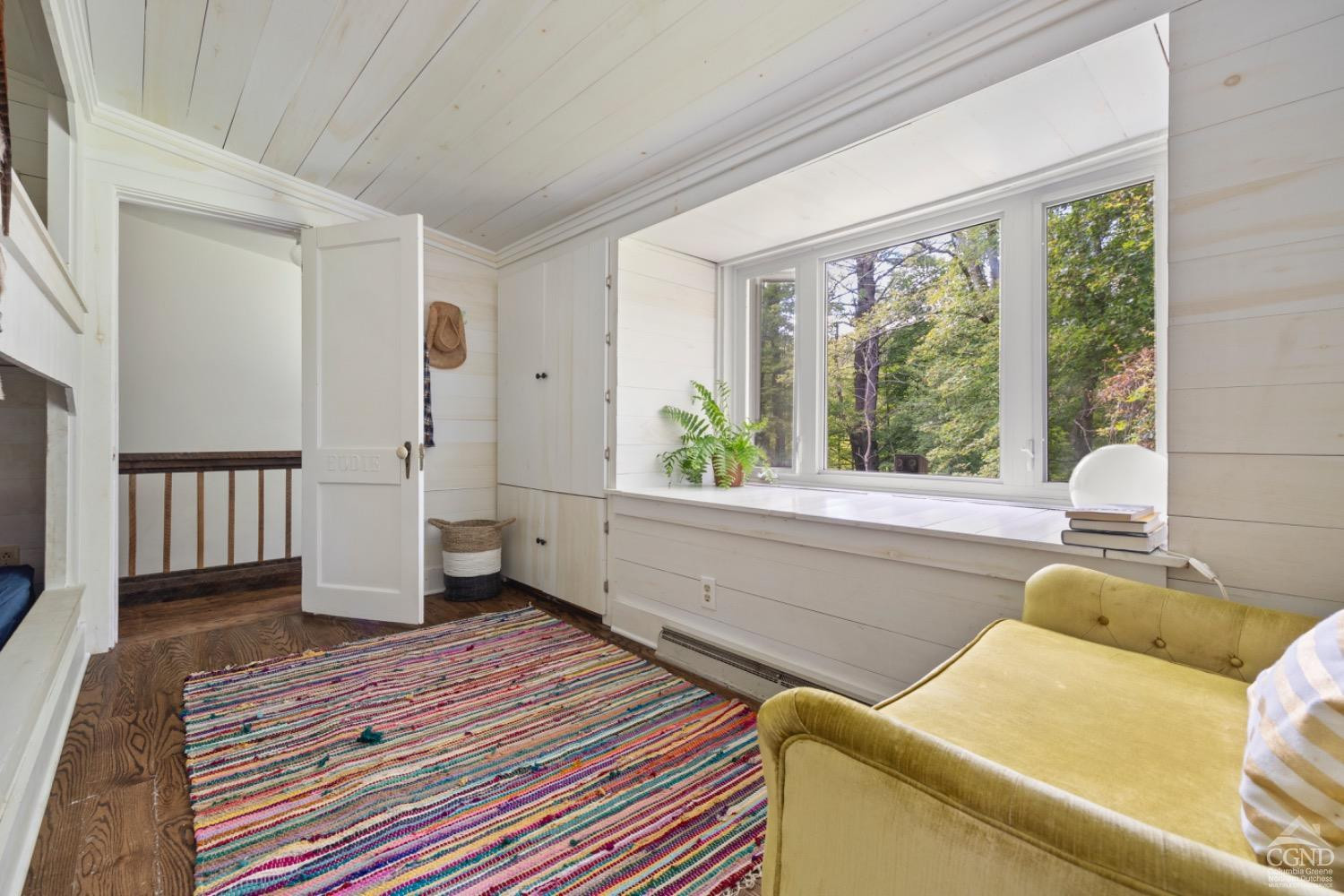 1487 County Rte 27 Craryville, NY 12521 - Photo 12 of 27 a living room with a bed furniture and a large window