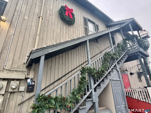 a outdoor view of a house with wooden stairs