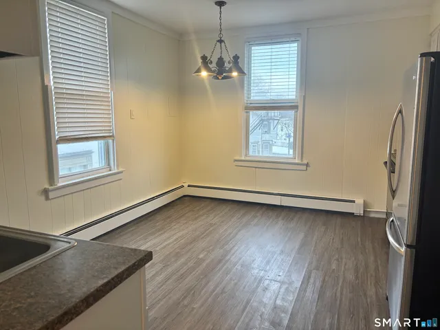 a view of a room with wooden floor and a window