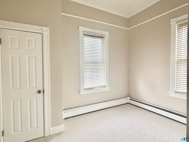 a white toilet sitting next to a bath tub