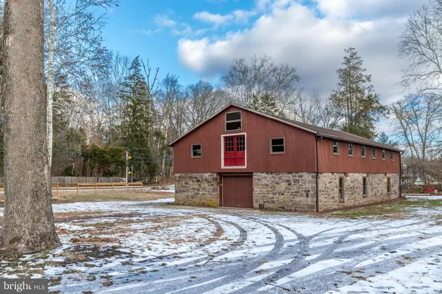 a view of a house with a yard covered with snow