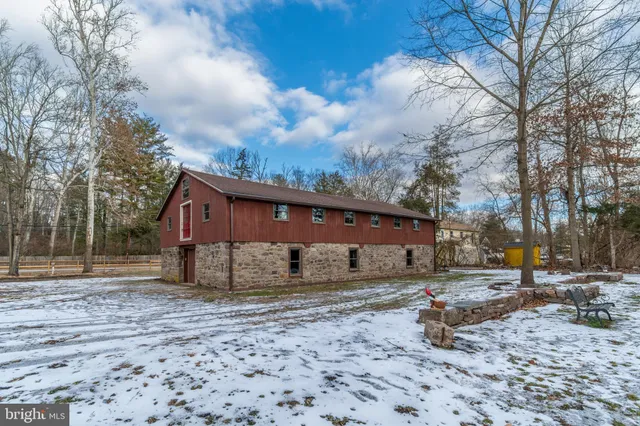 a view of a house with a yard covered with snow