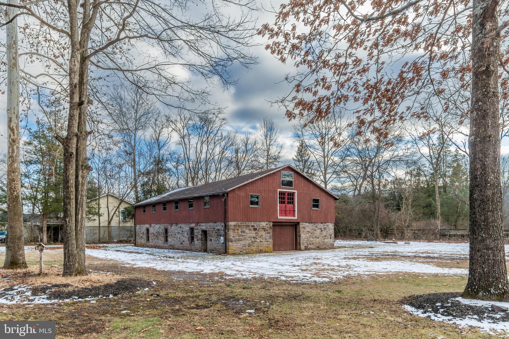 25 Risler Street Stockton, NJ 08559 - Photo 4 of 36 a front view of a house with a yard covered in snow