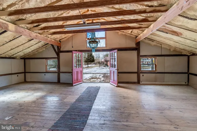 a view of a room with wooden floor