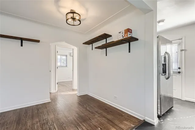 a view of a room with wooden floor and white walls