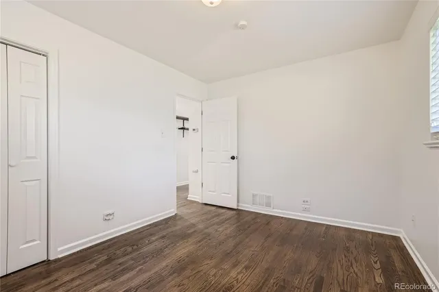 an empty room with wooden floor