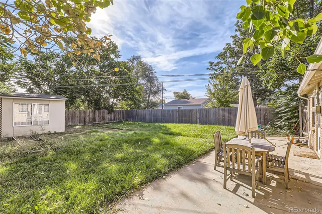 a view of backyard with seating and green space