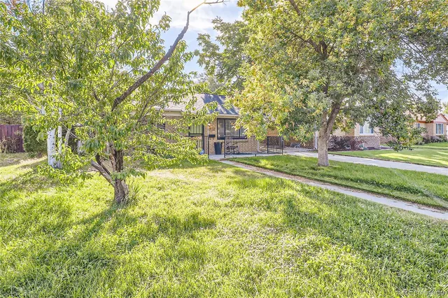 a view of yard with swimming pool and trees