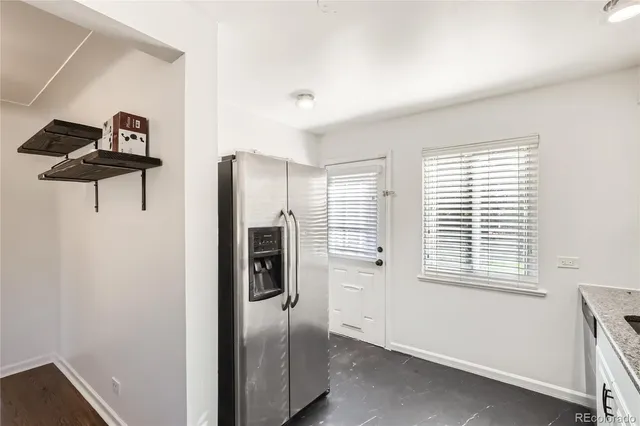 a kitchen with stainless steel appliances a refrigerator and a window