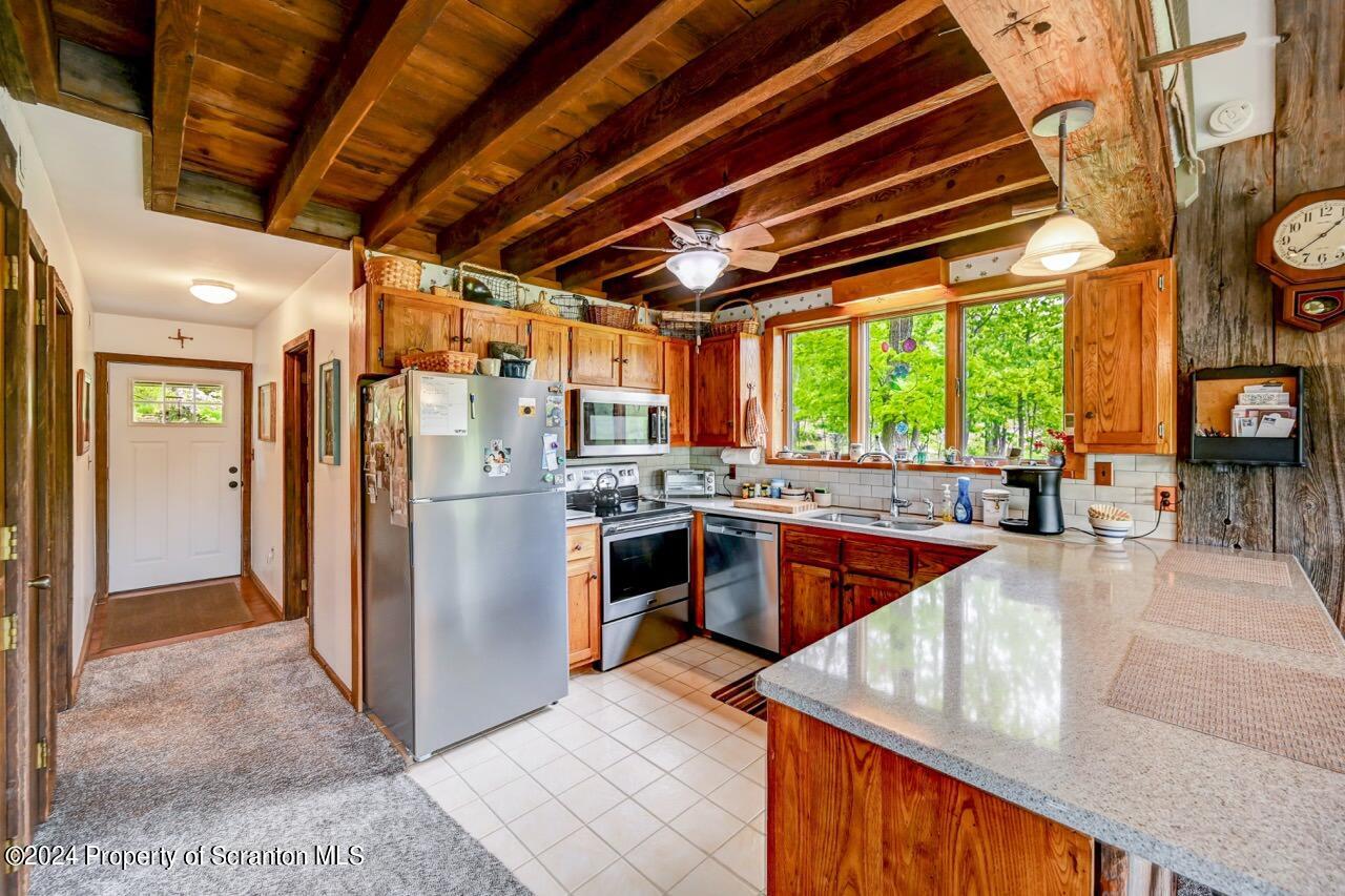 33 Hobbs Road Tunkhannock, PA 18657 - Photo 20 of 83 a kitchen with stainless steel appliances granite countertop a stove a refrigerator a oven with white cabinets and wooden floor