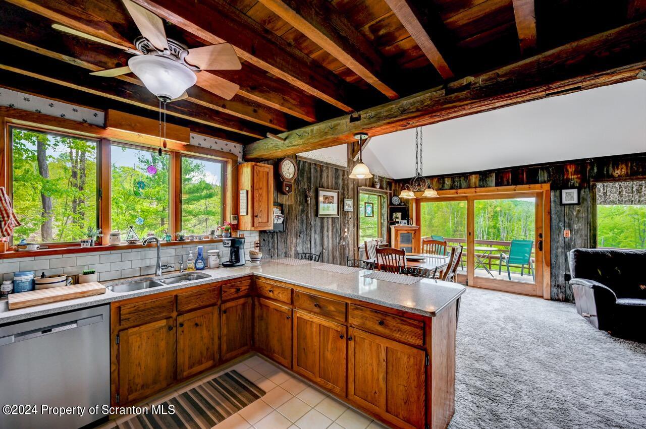 33 Hobbs Road Tunkhannock, PA 18657 - Photo 27 of 83 a kitchen with sink a large window and cabinets