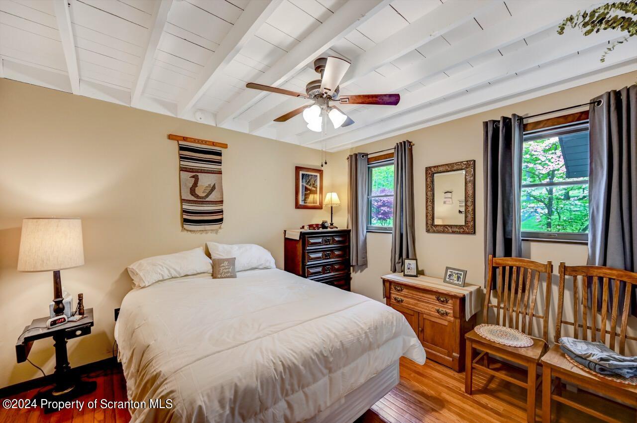 33 Hobbs Road Tunkhannock, PA 18657 - Photo 34 of 83 a spacious bedroom with a bed and a chandelier