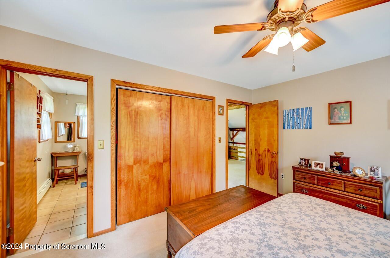 33 Hobbs Road Tunkhannock, PA 18657 - Photo 52 of 83 a bedroom with a bed and a chandelier