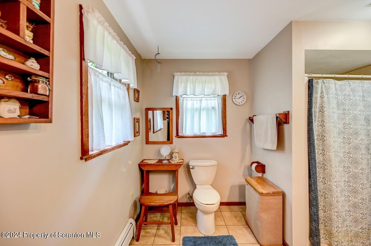 33 Hobbs Road Tunkhannock, PA 18657 - Photo 53 of 83 a bathroom with a toilet and a shower curtain