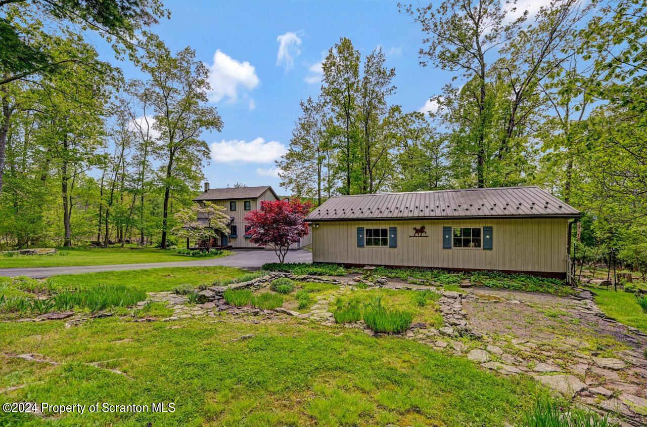 33 Hobbs Road Tunkhannock, PA 18657 - Photo 73 of 83 a backyard of a house with plants and large trees