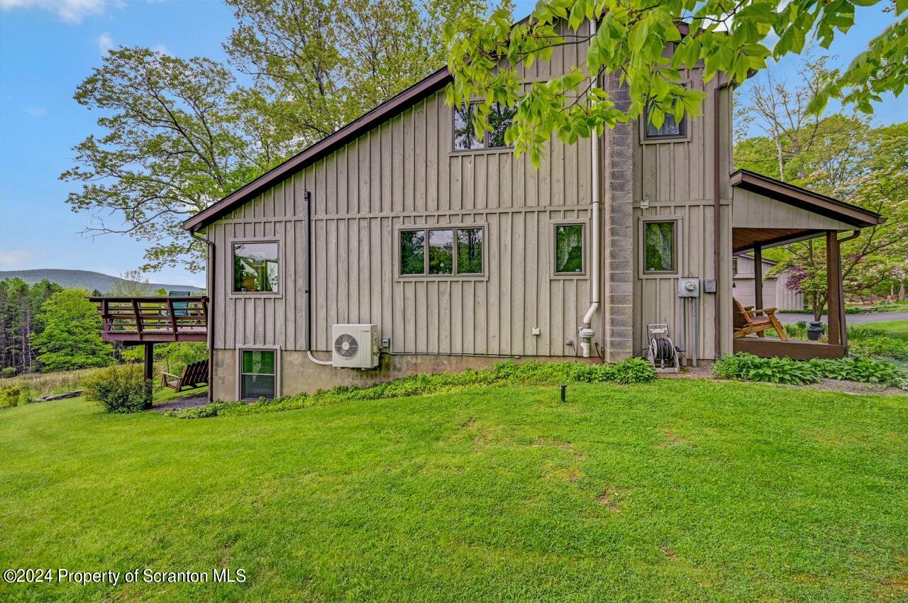 33 Hobbs Road Tunkhannock, PA 18657 - Photo 77 of 83 a backyard of a house with plants and wooden fence
