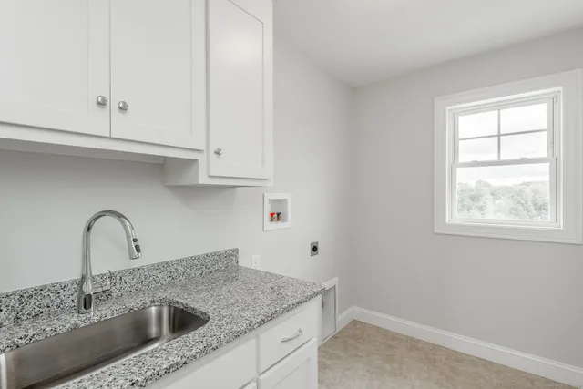 a view white cabinets with a sink