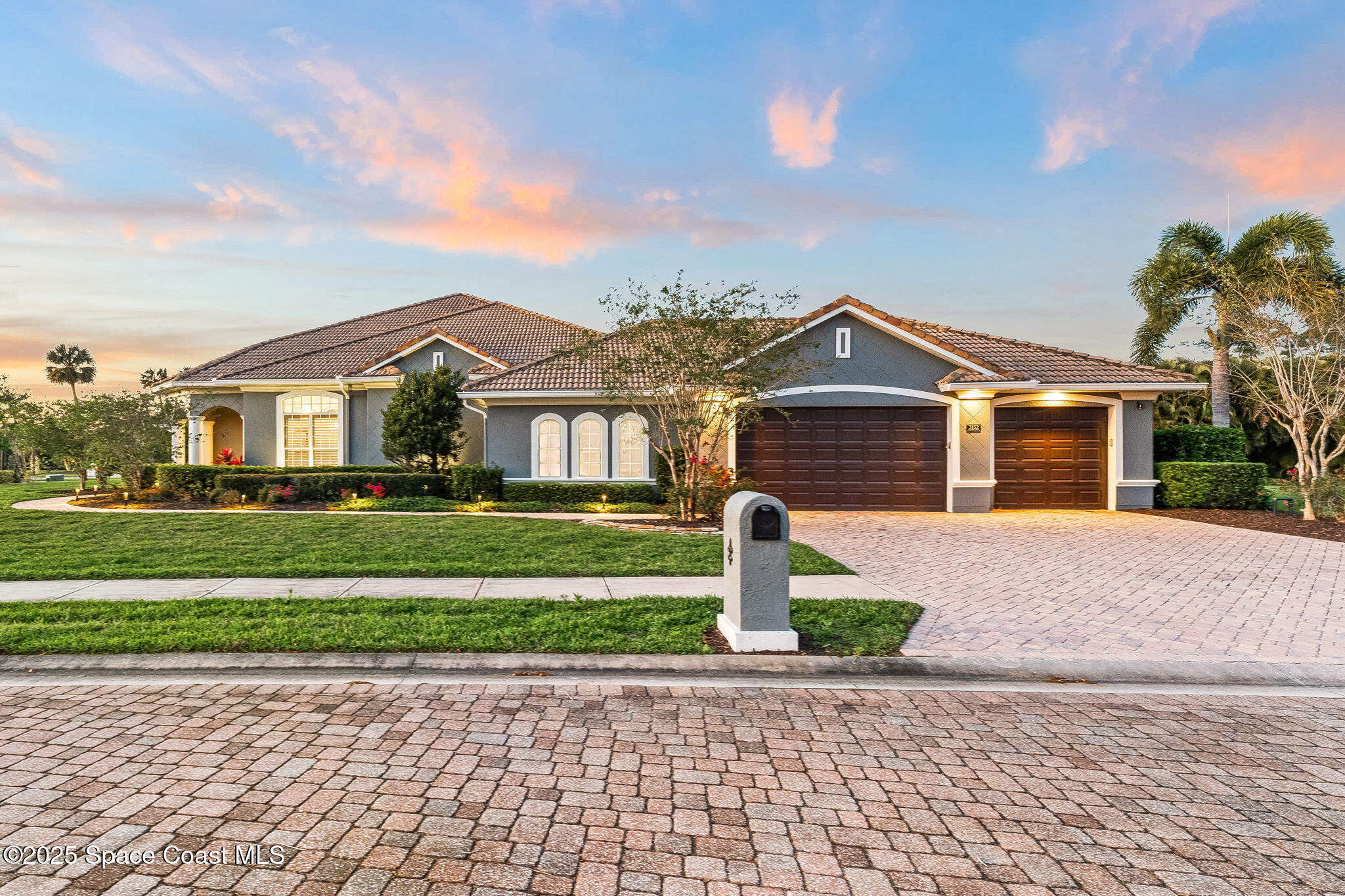3152 BELLWIND Circle Rockledge, FL 32955 - Photo 5 of 47 a front view of a house with a garden and yard