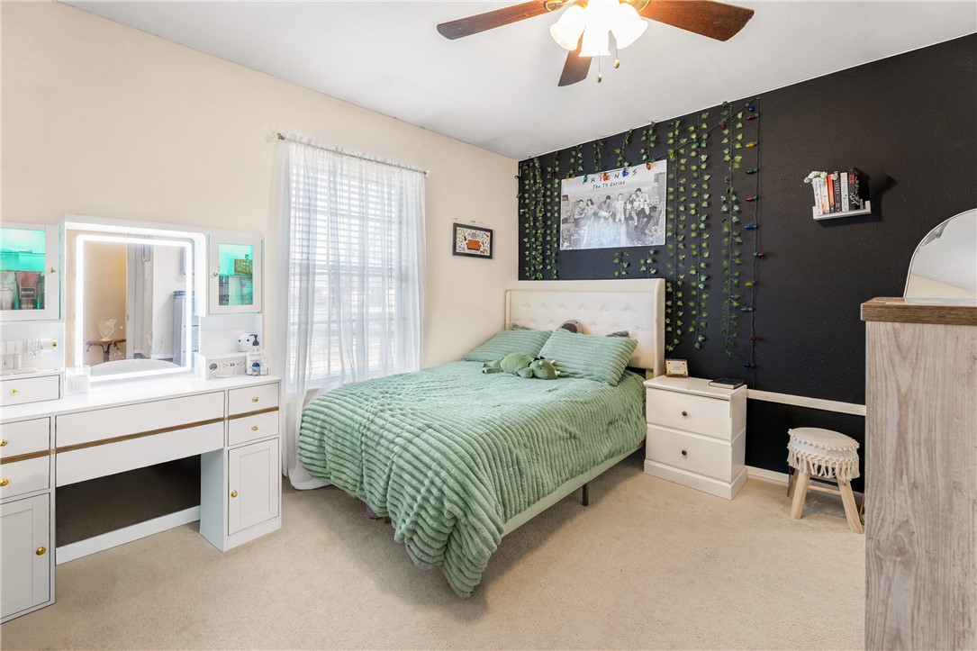 3319 Big Bend Drive Bryan, TX 77803 - Photo 16 of 19 a bedroom with a bed and a chandelier