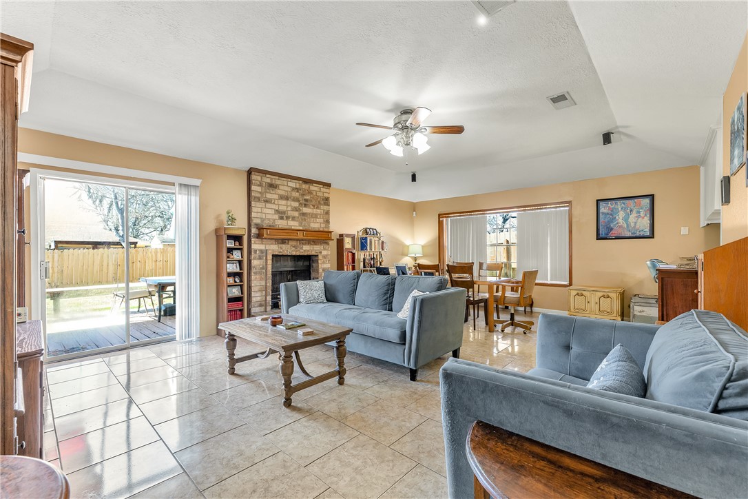 3319 Big Bend Drive Bryan, TX 77803 - Photo 2 of 19 a living room with fireplace furniture and a flat screen tv