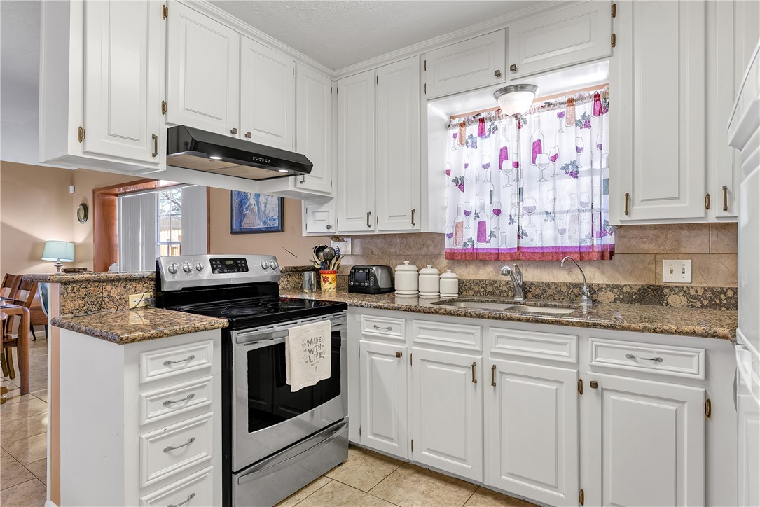 3319 Big Bend Drive Bryan, TX 77803 - Photo 3 of 19 a kitchen with granite countertop white cabinets and white appliances