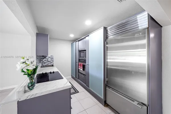 a kitchen with a refrigerator and a stove