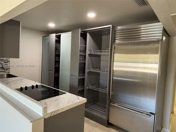 a kitchen with a refrigerator and a sink