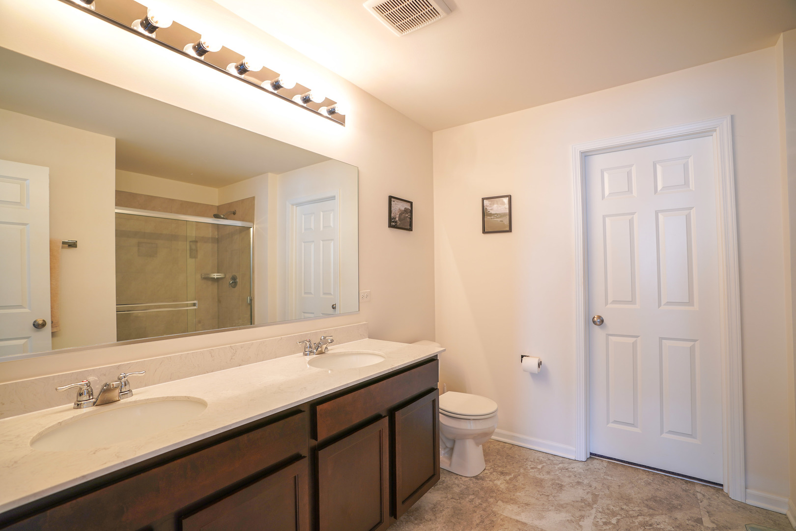 6611 Eich Drive Joliet, IL 60431 - Photo 15 of 21 a bathroom with a granite countertop sink a toilet and a mirror