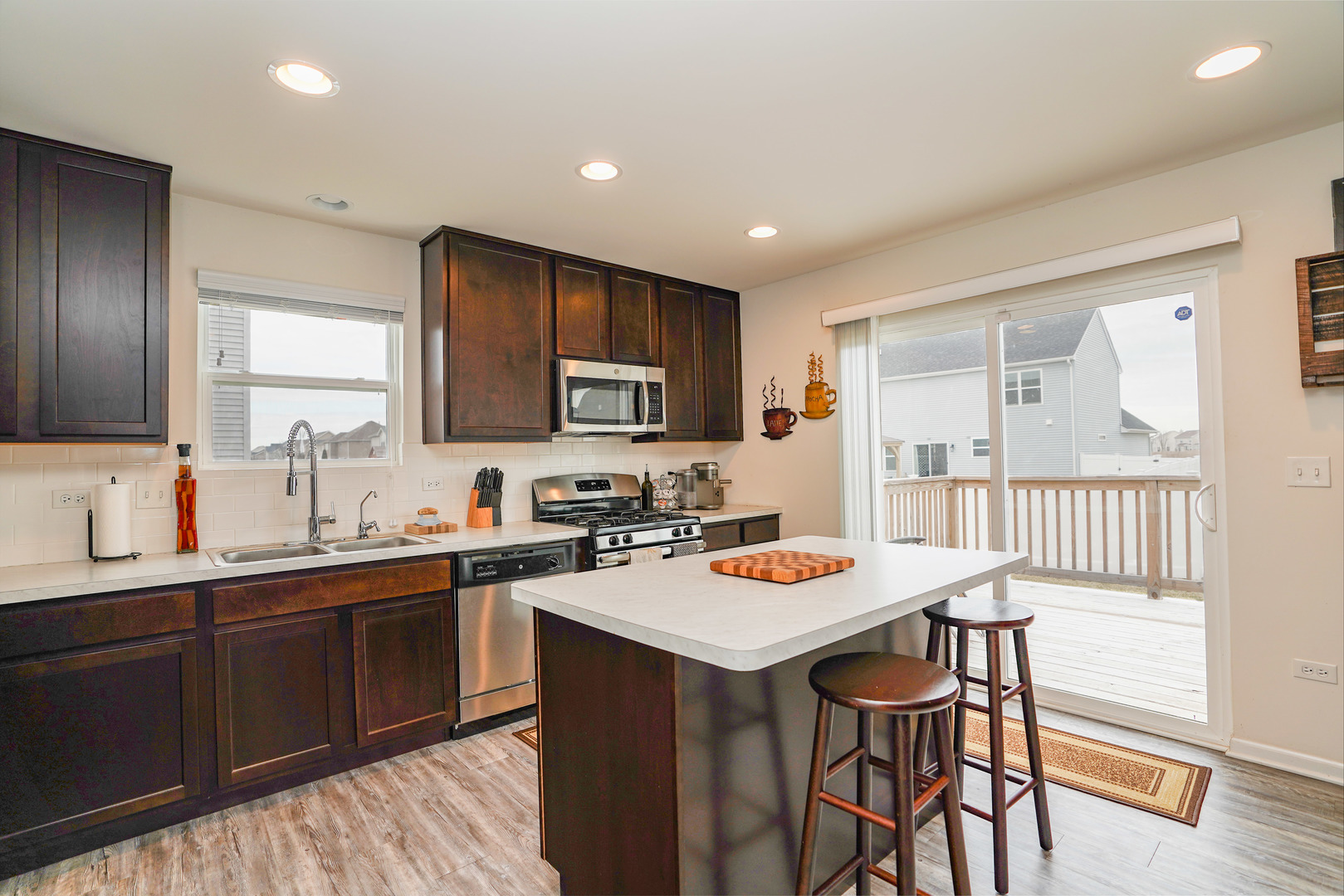 6611 Eich Drive Joliet, IL 60431 - Photo 4 of 21 a kitchen with a sink a stove a refrigerator cabinets and a dining table