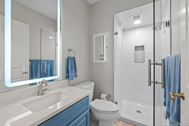 a bathroom with a sink toilet and shower