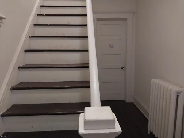 a living room with furniture a rug and a table