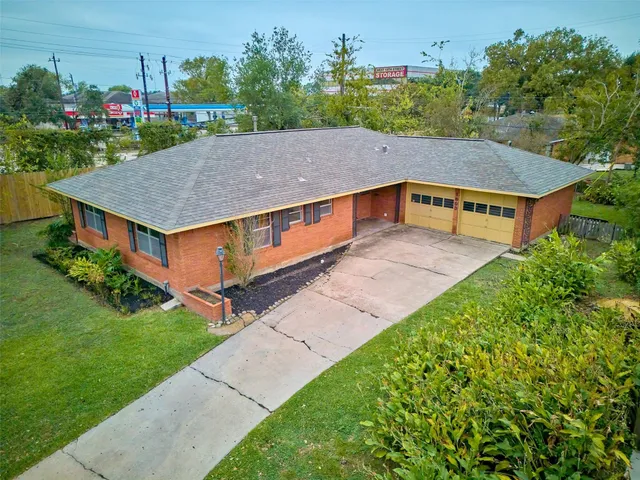 a aerial view of a house with a yard table and chairs