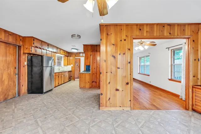 a view of a hallway with wooden walls
