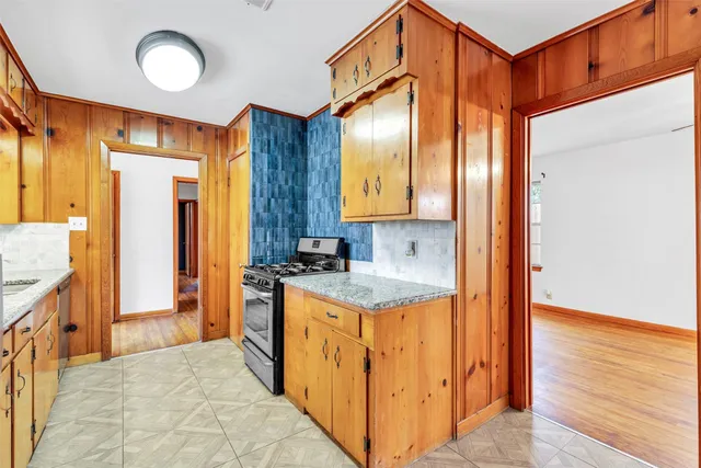 a kitchen with granite countertop a sink and a refrigerator