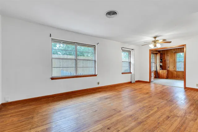 a view of a hallway with wooden floor and entryway