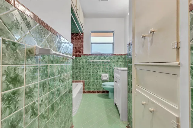 a bathroom with a sink a mirror and a toilet