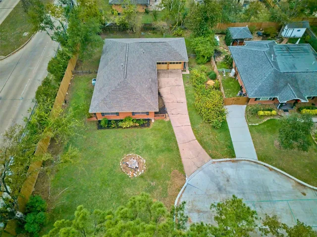 an aerial view of residential houses with outdoor space and swimming pool