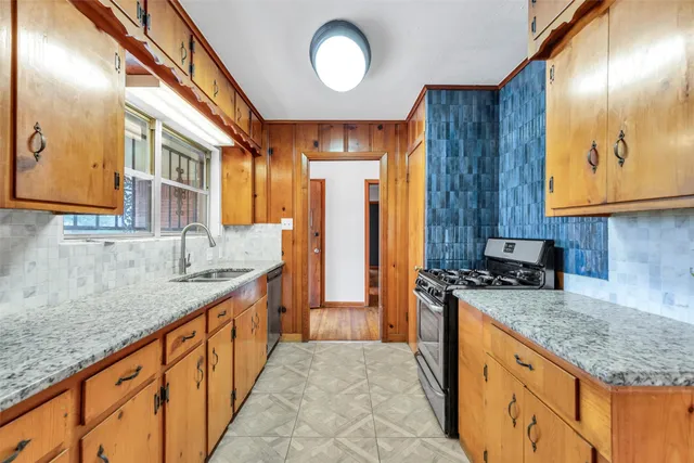 a kitchen with stainless steel appliances granite countertop a sink and a cabinets