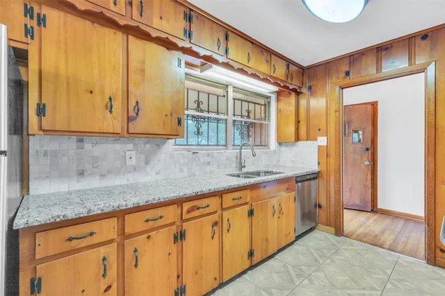 a kitchen with stainless steel appliances granite countertop a sink and cabinets