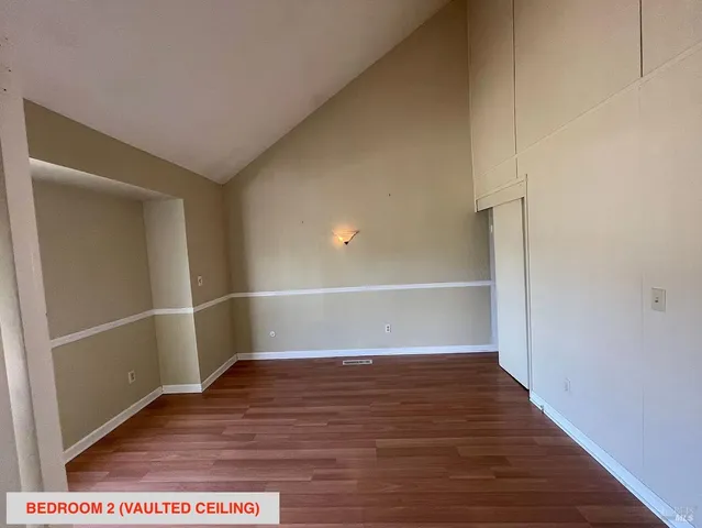 a view of an empty room and wooden floor